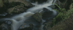 Slow shutter speed creating motion blur in waterfall