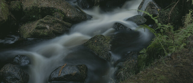 Slow shutter speed creating motion blur in waterfall